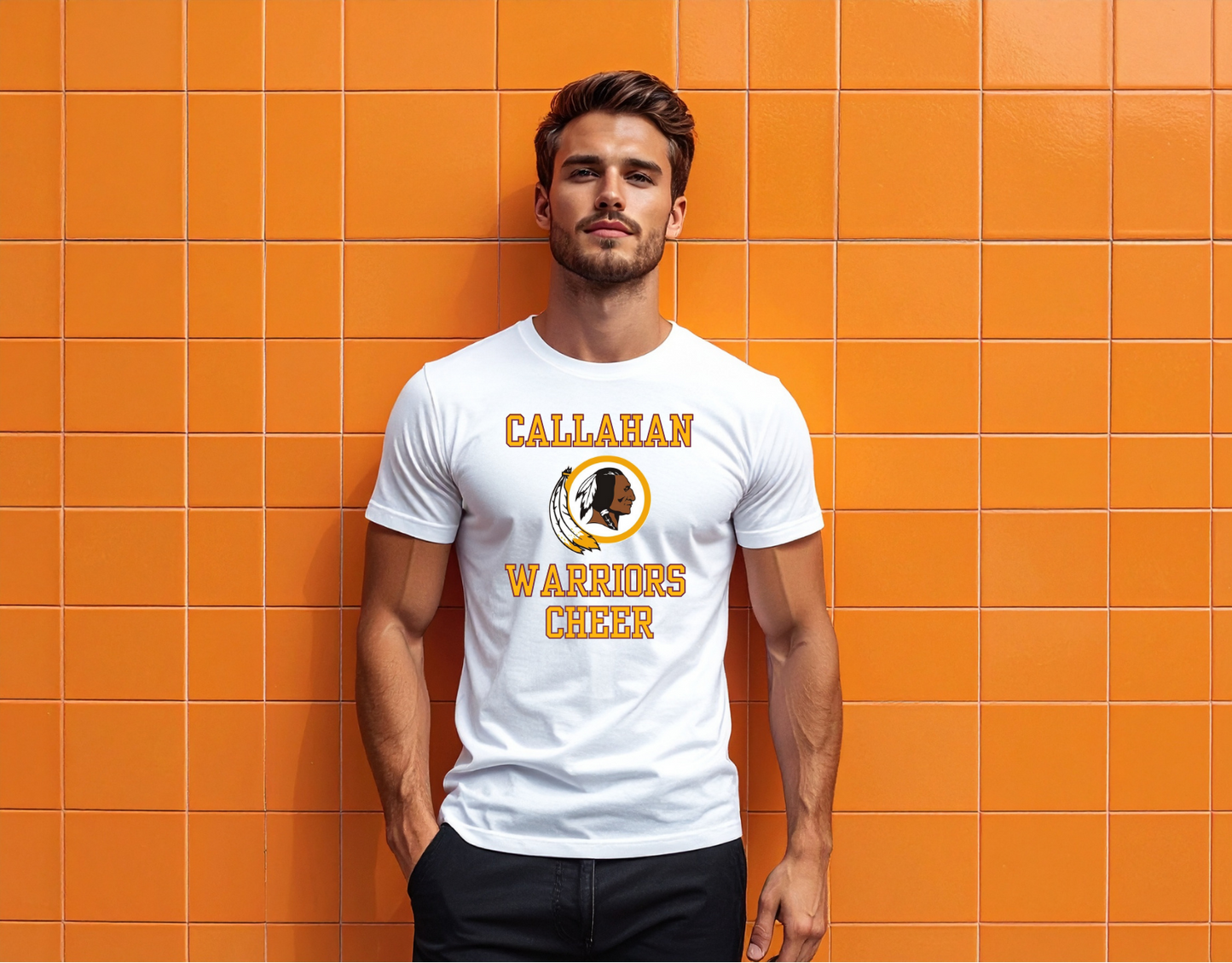 Man wearing a white t-shirt with 'Callahan Warriors' design against an orange tiled wall.