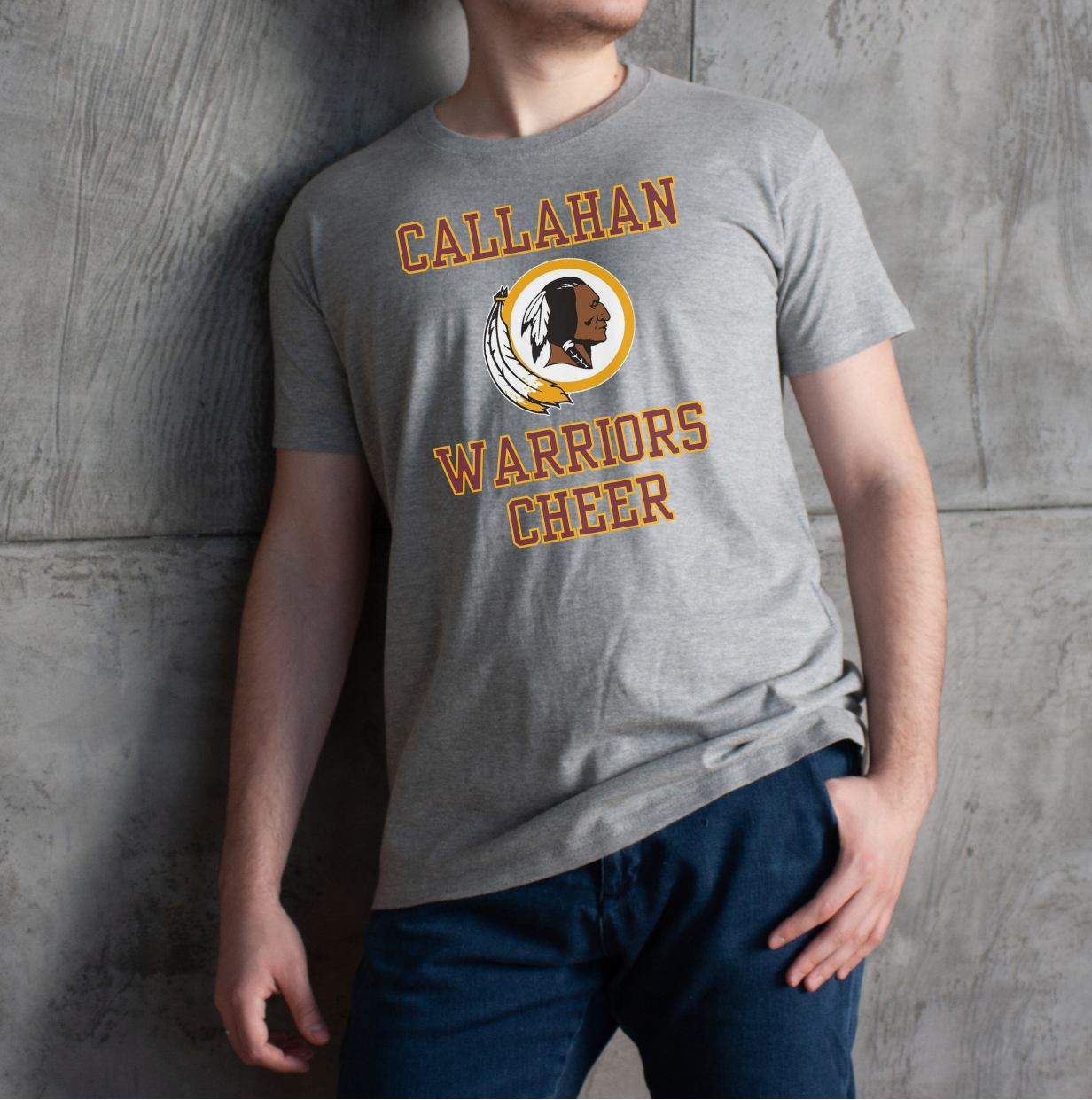 Person wearing a gray t-shirt with 'Callahan Warriors Cheer' text and logo against a concrete wall.